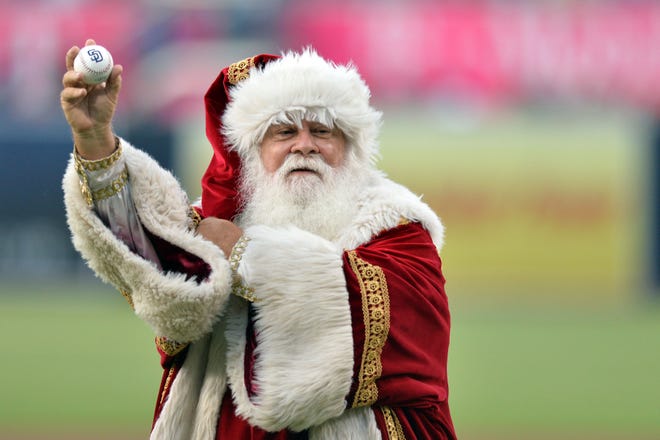 Santa Claus prepares to throw out the ceremonial first pitch before the game between the Los Angeles Dodgers and San Diego Padres at Petco Park.