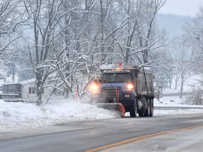 A snowplow clears snow along Mule Academy Road in front of the Augusta Regional Clinic in Fishersville on Monday, Dec. 10, 2018.
