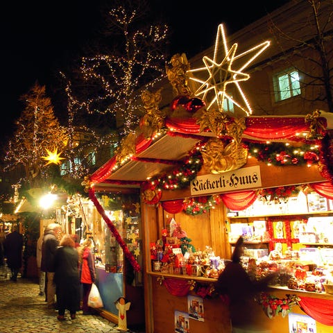 Christmas lights glow over the stalls at the...