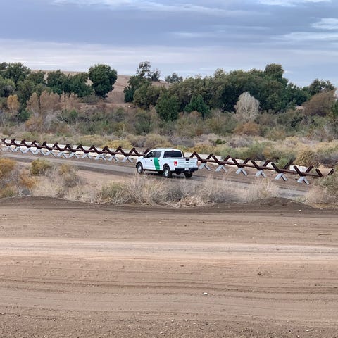 A Border Patrol vehicle drives past Normandy...