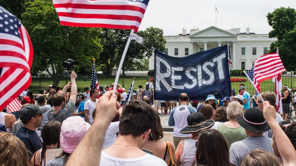 Protesters gather near the White House in...