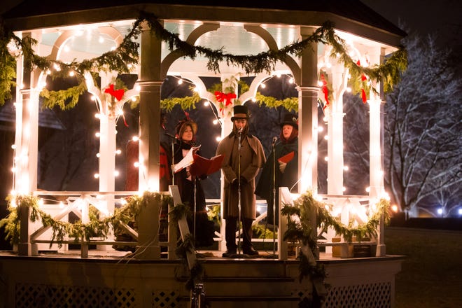 Carolers sing holiday favorites from a gazebo during Holiday Nights.
