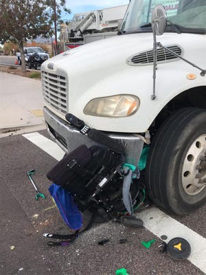 A woman in an electric wheelchair was injured when she was struck by a dump truck near 85th Street and Indian School Road in Scottsdale.