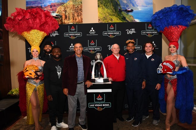 ASU's Manny Wilkins, Eno Williams and Herm Edwards pose with Fresno State's Jeff Tedford, Marcus McMaryion and George Helmuth during a media event in Las Vegas on Tuesday.