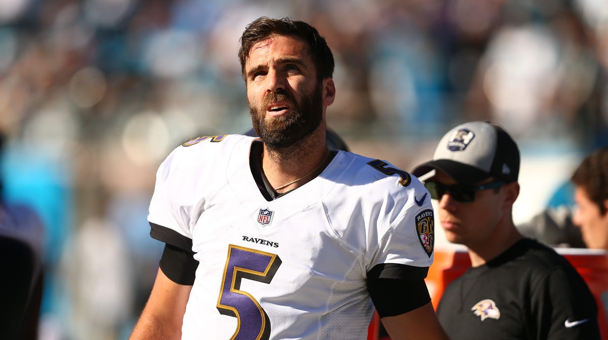 Baltimore Ravens quarterback Joe Flacco (5) stands on the sidelines in the game against the Carolina Panthers at Bank of America Stadium.