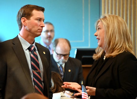 Sen.  Dave Hildenbrand (R-Lowell) talks with Sen. Tanya Schuitmaker (R-Lawton) as the Michigan Senate considers bills during "lame duck" session in Lansing on Dec. 12, 2018.