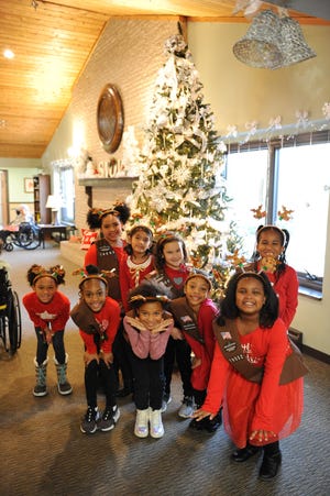 Woodcreek Brownie Troop #79802 poses for a photo after entertaining seniors at Courtyard Manor of Farmington Hills.