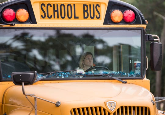 Escambia District Schools buses depart Pensacola High School in Pensacola on Thursday, December 13, 2018.