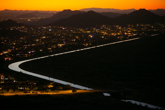 The CAP Canal winds through a neighborhood on one side and the desert on the other in Phoenix as seen from the Deem Hills Recreation Area on December 12, 2018.