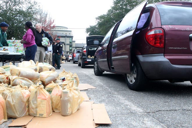 Cars drive through to pick up donations when as the Leon County Sheriff's Office partners with FarmShare to give Leon county families food for the holiday season, Thursday, Dec. 13, 2018. 
