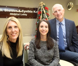 Diane Dinsmore, left, of Fishkill, New York; her daughter Kerri Dinsmore of Hastings-on-Hudson, New York; and Dr. Jeffrey Oppenheim of Piermont, New York, get together for a photo Dec. 12, 2018, at Nyack Hospital in New York nearly 20 years after Oppenheim on Christmas Day 1998 performed seven hours of emergency brain surgery on a 7-year-old Kerri Dinsmore.