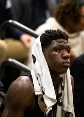 East Memphis Mustangs forward, Malcolm Dandridge (35) watches from the bench during the second half of the basketball game, Thursday, Dec. 13, 2018.