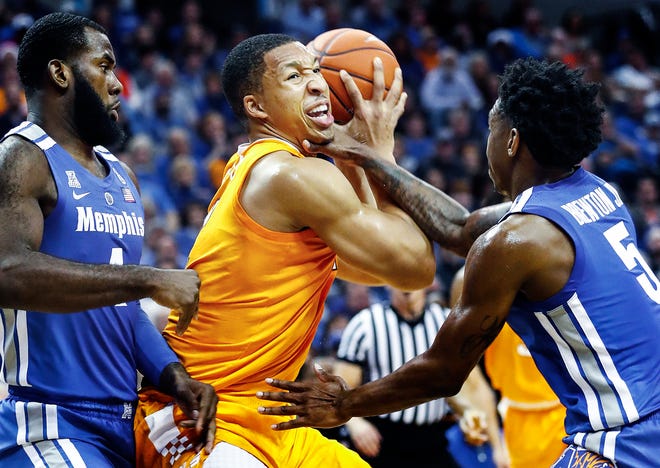 Tennessee guard Grant Williams (middle) drives the lane against Memphis defenders Raynere Thornton (left) and Kareem Brewton Jr. (right) during Saturday's game.