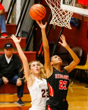 Stewarts Creek's Zhordan Shannon goes up for a layup as Riverdale's Jalyn Holcomb defends.