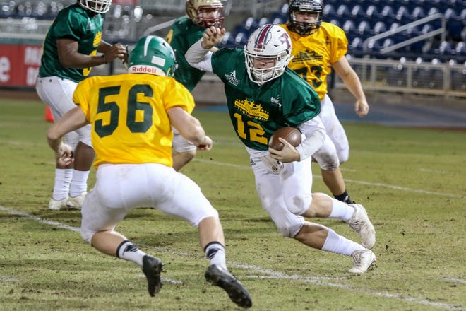 Tate quarterback Hunter Riggan (12) keeps the ball and runs against the East team in Pensacola Sports' annual Subway High School All-Star Game at Blue Wahoos Stadium on Friday, December 14, 2018. Players from Escambia County schools made up the West team and players from schools in Santa Rosa & Okaloosa counties made up the East team.