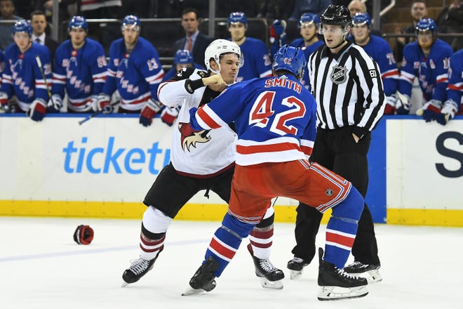 Dec 14, 2018; New York, NY, USA; New York Rangers defenseman Brendan Smith (42) and Arizona Coyotes center Nick Cousins (25) fight in the first period at Madison Square Garden. Mandatory Credit: Catalina Fragoso-USA TODAY Sports