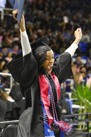 An MTSU student's exuberance and relief combine into a shout of joy as she holds her diploma aloft in Murphy Center Saturday, Dec. 15, during the university's fall 2018 afternoon commencement ceremony. MTSU presented 1,731 degrees to students in dual ceremonies, including 1,471 undergraduates and 260 graduate students in the celebrations.