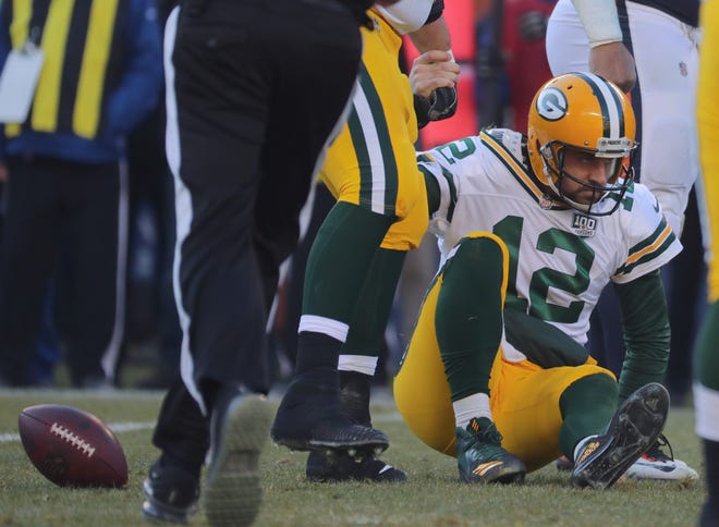 Green Bay Packers quarterback Aaron Rodgers (12) is helped up after being sacked during the fourth quarter of their game Sunday, December 25, 2018 at Soldier Field in Chicago, Ill. The Chicago Bears beat the Green Bay Packers 24-17.

MARK HOFFMAN/MILWAUKEE JOURNAL SENTINEL