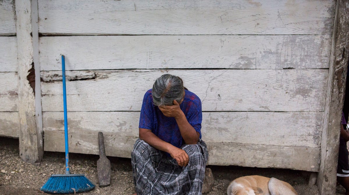 Elvira Choc, 59, Jakelin Amei Rosmery Caal's grandmother, rests her head on her hand in front of her house in Raxruha, Guatemala, on Dec. 15, 2018. The 7-year old girl died in a Texas hospital two days after being taken into custody by border patrol agents in a remote stretch of New Mexico desert.