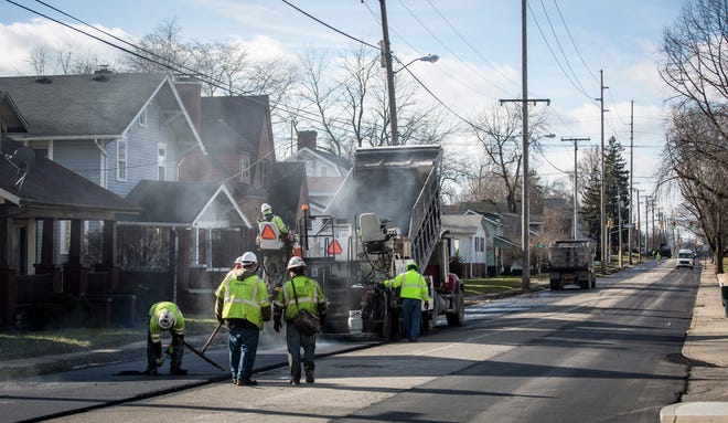 Construction crews work on paving West Jackson Street in 2019 between West White River Road and Tillotson Avenue.