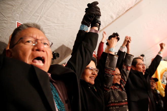 Myron Lizer, left, Dottie Lizer, Phefelia Herbert-Nez and Jonathan Nez celebrate their win in the Navajo Nation presidential and vice presidential election on Nov. 6 in Window Rock, Ariz.