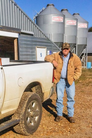 In this Nov. 21, 2018, photo provided by the Midwest Center for Investigative Reporting, Kevin Kemp poses for a photo at his chicken farm near Carthage, Miss. After 20 years, Kemp is getting out of the chicken business. He raised millions of pounds of chicken since 1996, alongside his father and brother. But Kemp said even though he's done well as a poultry grower, raising chickens is "not all it's cracked up to be."