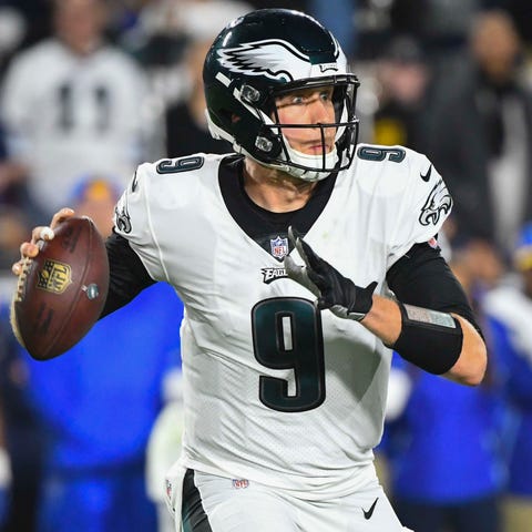 Eagles quarterback Nick Foles rolls out to avoid...