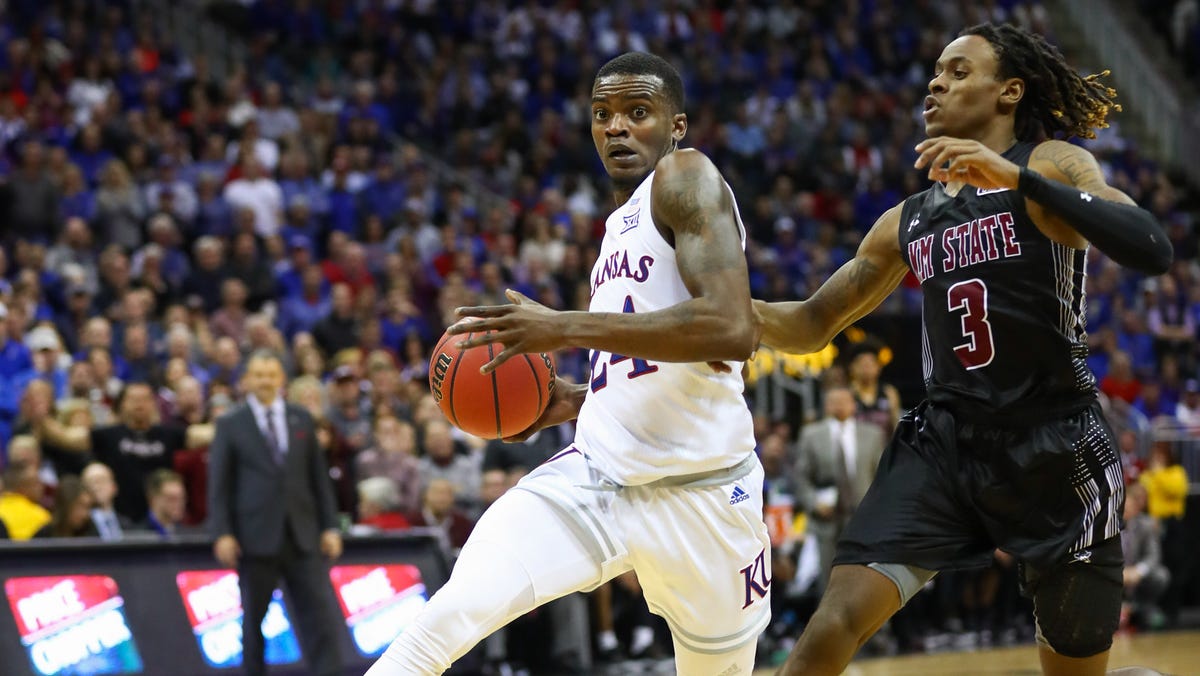 Kansas guard Lagerald Vick drives to the basket against New Mexico State guard Terrell Brown during their game at  Sprint Center.