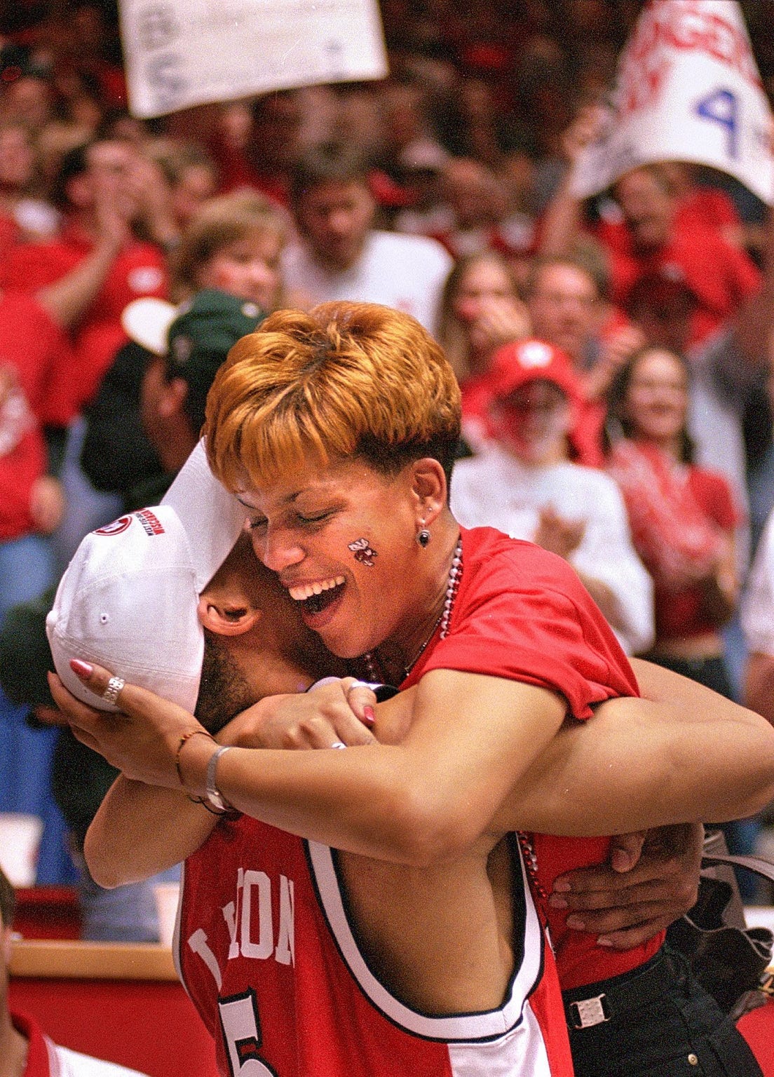 Wisconsin's Maurice Linton hugs his mother, Cynthia, in the stands to celebrate Wisconsin's victory over Purdue.