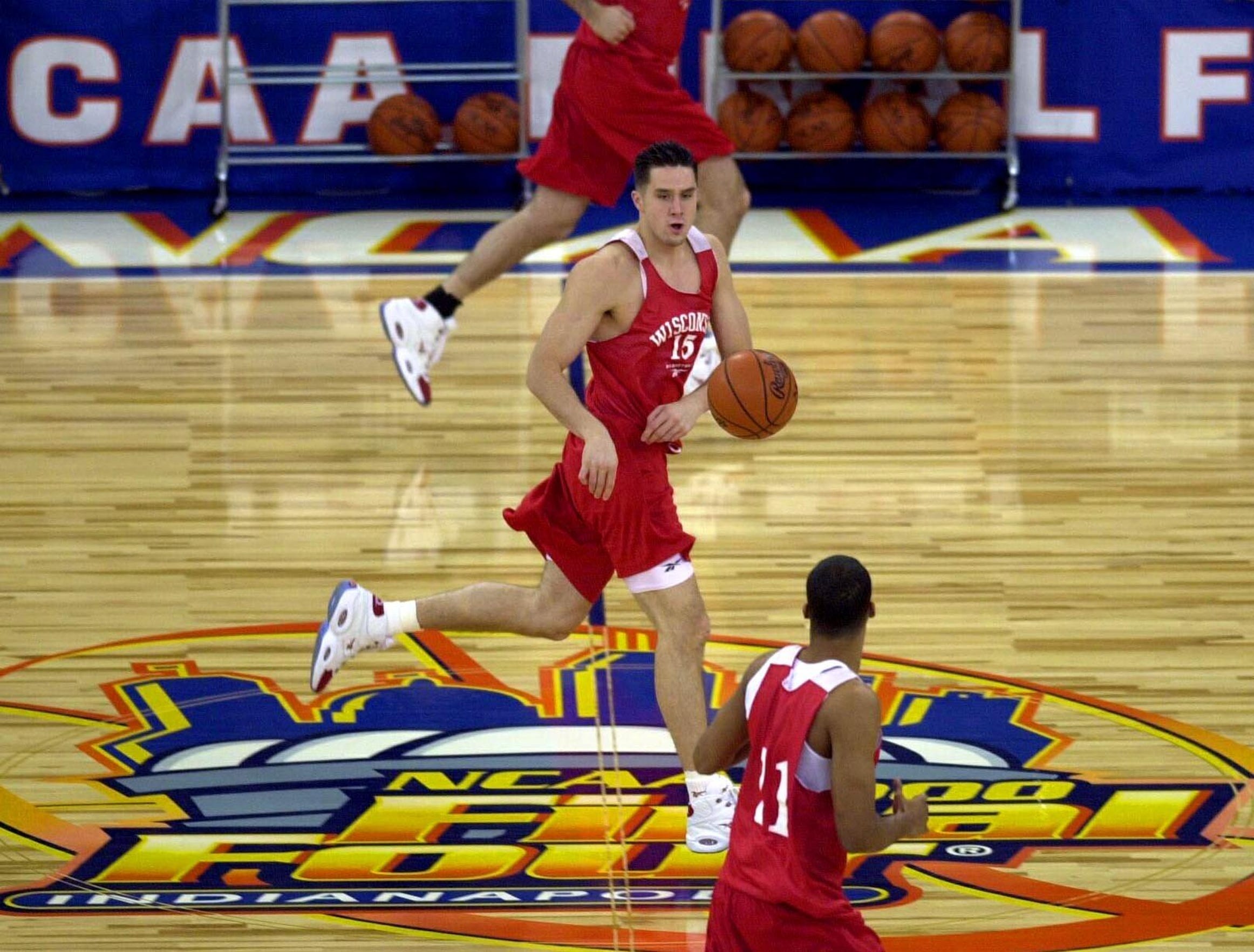 Wisconsin's Andy Kowske, of Brookfield, (center) runs a fast break with teammates as he crosses over midcourt of the RCA Dome in Indianapolis Friday during the team practice.