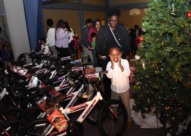 Landon Clarkston, 5, a pre-Kindergarten student at Mabel Brasher Montessori Elementary School, is excited about being one of 30 students to get a bicycle from the Academy Sports + Outdoors holiday bike donation program. With Landon is his mother Mardescia Clarkston. The Alexandria Academy Sports + Outdoors surprised 30 Mabel Brasher Montessori Elementary School students with bicycles and helmets Wednesday, Dec. 19, 2018. The Mabel Brasher students were among the 5,000 students in 16 states that were given bikes as part of Academy's holiday bike donation program. The bikes are a reward for children who have perfect attendance, academic performance, good behavior and may have a need for the gift.