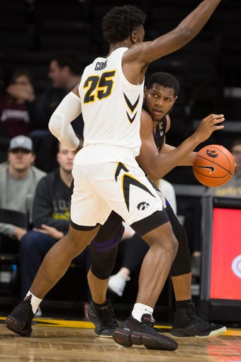 Western Carolina junior forward Carlos Dotson (4) drives against Iowa junior forward Tyler Cook (25) in the second half at Carver Hawkeye Arena in Iowa City on Tuesday, Dec. 18, 2018.