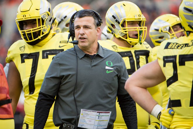 Nov 23, 2018; Corvallis, OR, USA; Oregon Ducks head coach Mario Cristobal talks to his players during a time out in the first half against the Oregon State Beavers at Reser Stadium. Mandatory Credit: Troy Wayrynen-USA TODAY Sports