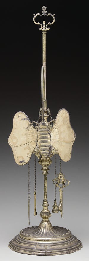 This unusual light, a Lucerne whale oil lamp, is made of brass and is silver plated. It gives the light from a small burning flame. The unusual shape coaxed a bid of $242.