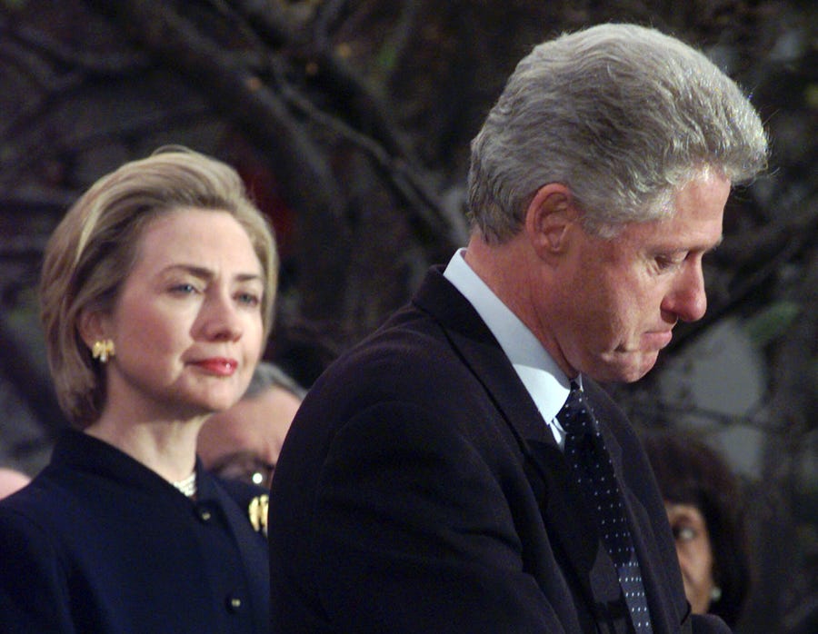 Former fist lady Hillary Rodham Clinton watches President Clinton pause as he thanks those Democratic members of the House of Representatives who voted against impeachment in this Dec. 19, 1998 file photo.