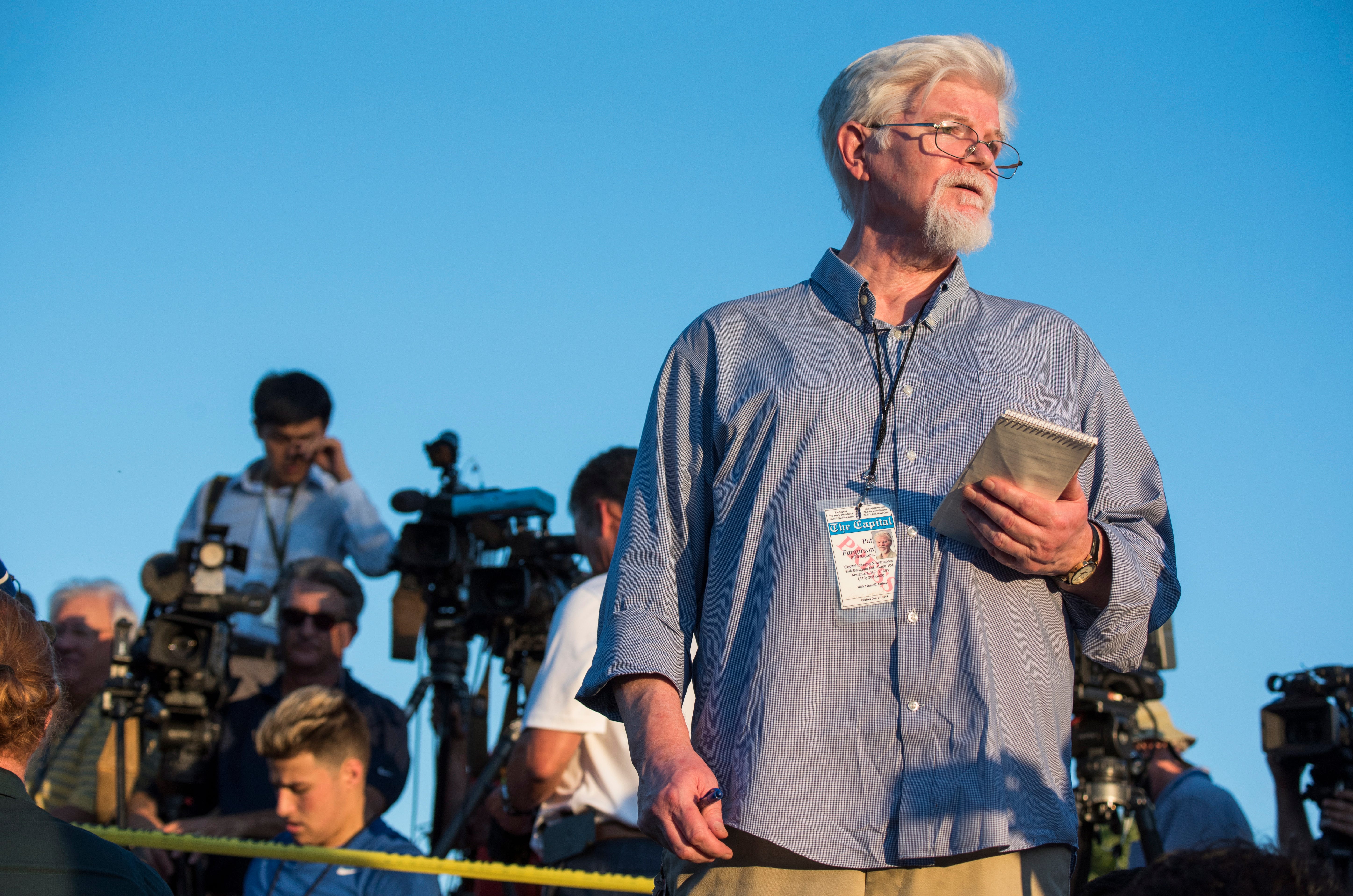 Pat Furgurson, staff reporter of the Capital Gazette, reports outside the scene of a shooting at the Capital Gazette building in Annapolis, Md., on June 28, 2018. Five newspaper employees were killed and several injured in the shooting.