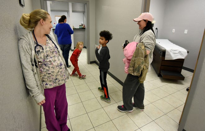 Liam Hicks, 8, waves bye to nurse Leah Hatfield, left, after getting his ear infection rechecked at the Servolution Health Services in Speedwell, Tennessee, Thursday, Dec. 20, 2018.  TennCare has suspended certain payments to any new rural health clinic in Tennessee while it comes up with new payment rules.