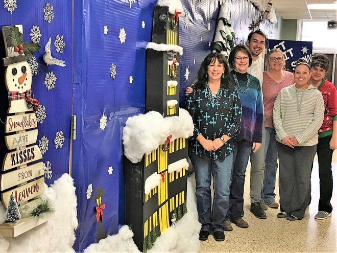 Lincoln County Treasurer Beverly Calaway and her staff wish a Merry Christmas to citizens of the county as they pose next to the annually decorated Christmas wall in the county courthouse. From left are Chief Deputy Sherrie Huddleston, Treasurer Beverly Calaway, Deputy Troy Niederstadt, Finance Officer Terri Knight, Deputy Faithe Samora and Deputy Rose Ann Romero.