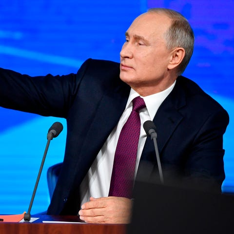 Russian President Vladimir Putin gestures during...