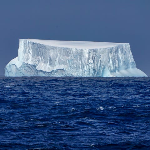 A blue-tinged iceberg, it's backside worn smooth...