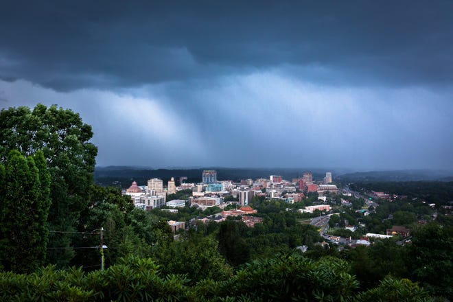 Heavy rain moves in over downtown Asheville as seen from Town Mountain Road Jun. 26, 2018. 