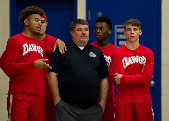 Bosse Head Coach Shane Burkhart and the varsity team watch the end of the JV game against Memorial Tuesday, Dec. 11, 2018. 