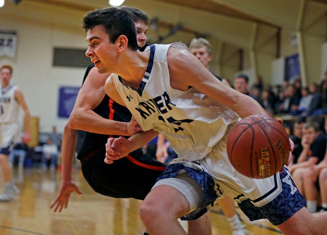 Nick Otto of Xavier drives the baseline against the defense of Nate Jensen of West De Pere in a Bay Conference basketball game Friday at Torchy Clark Gym in Appleton.
Ron Page/USA TODAY NETWORK-Wisconsin