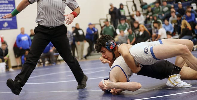 Robert Gomez Jr. of North Kitsap battles Tim Porter of Olympic during the 132-pound championship match at the North Mason Classic on Dec. 22 in Belfair. Gomez, ranked second in the state in his classification and weight class, won the tournament title.