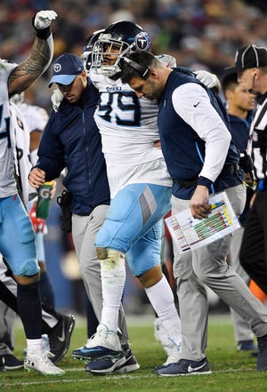 Titans coach Mike Vrabel helps defensive tackle Jurrell Casey (99) off the field after his injury in the fourth quarter Saturday.