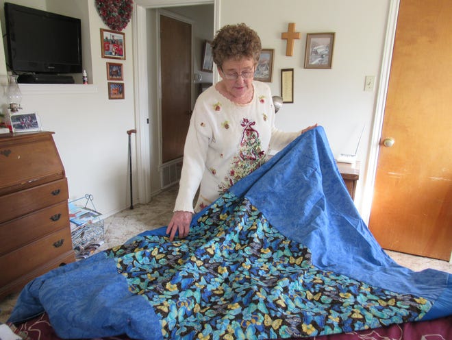 La Verne Redman describes how she color coordinated the different material pieces of her quilt, Monday, Dec. 18, 2018 at her home in Miles, Texas.