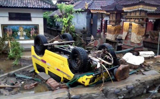 A handout photo made available by the Indonesia's national disaster management (BNPB) shows a ruined car that was rolled over after a tsunami hit Sunda Strait, in Anyer, Banten, Indonesia, 23 December 2018. According to BNPB, at least 43 people dead and 584 others have been injured.