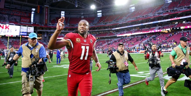 Arizona Cardinals wide receiver Larry Fitzgerald waves to the fans after their 31-9 loss to the Los Angeles Rams on Dec. 23 at State Farm Stadium.