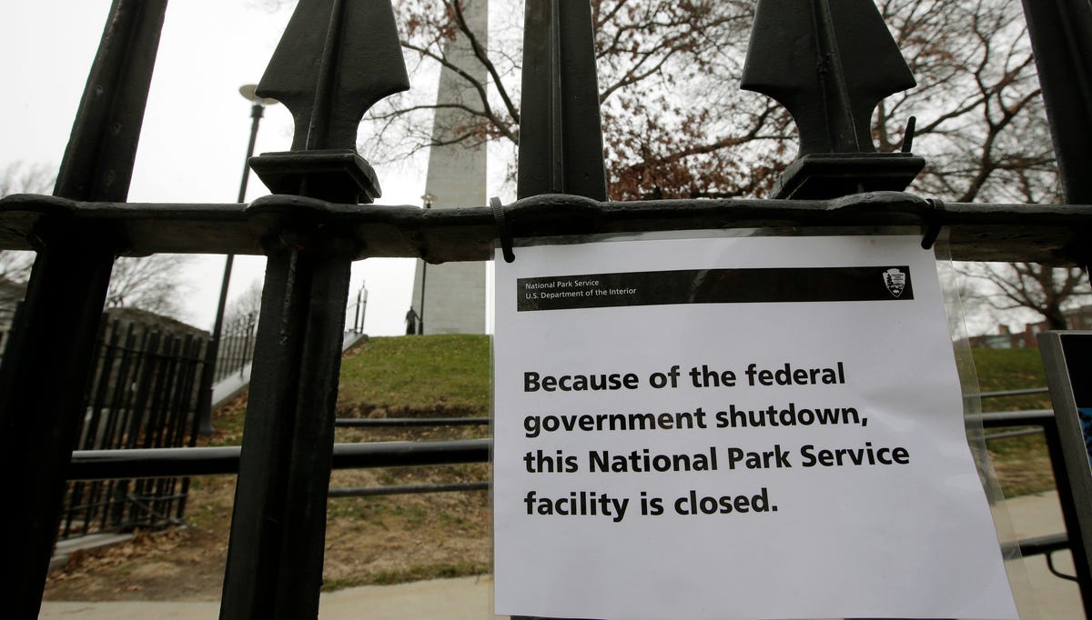 A sign is posted on a fence near an entrance to the Bunker Hill Monument, Monday, Dec. 24, 2018, in Boston. The historic site, erected to commemorate the Revolutionary War Battle of Bunker Hill, and run by the National Park Service, was closed Monday due to a partial federal government shutdown. The federal government is expected to remain partially closed past Christmas Day in a protracted standoff over President Donald Trump's demand for money to build   a border wall with Mexico. (AP Photo/Steven Senne) ORG XMIT: MASR101