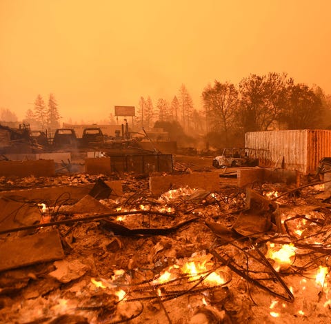 Businesses burn under a darkened smokey sky in Par